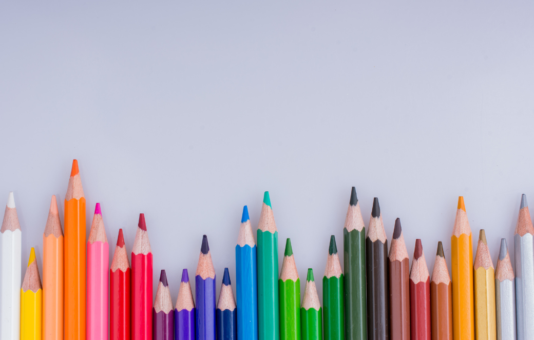 A line of sharpened colored pencils