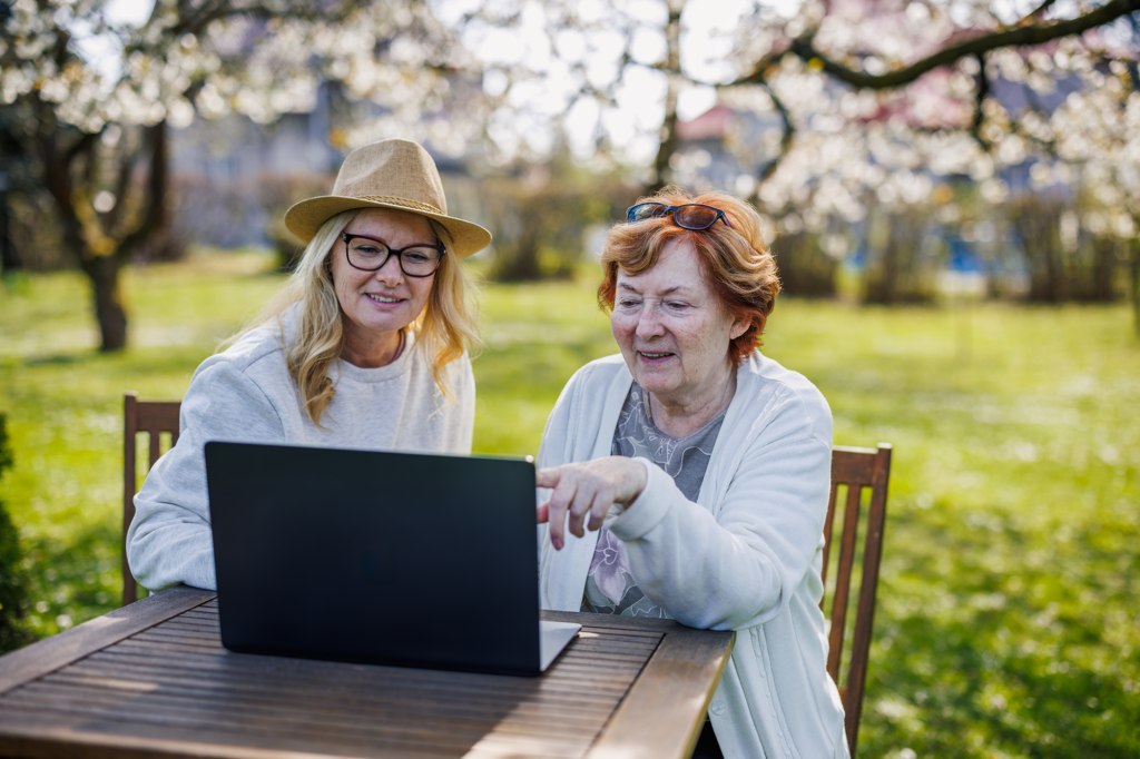 Mother and Daughter exploring open enrollment on laptop